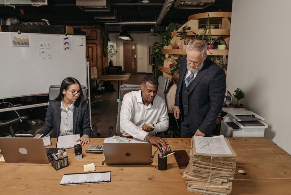 A multicultural team working together in a modern office setting, focusing on documents.